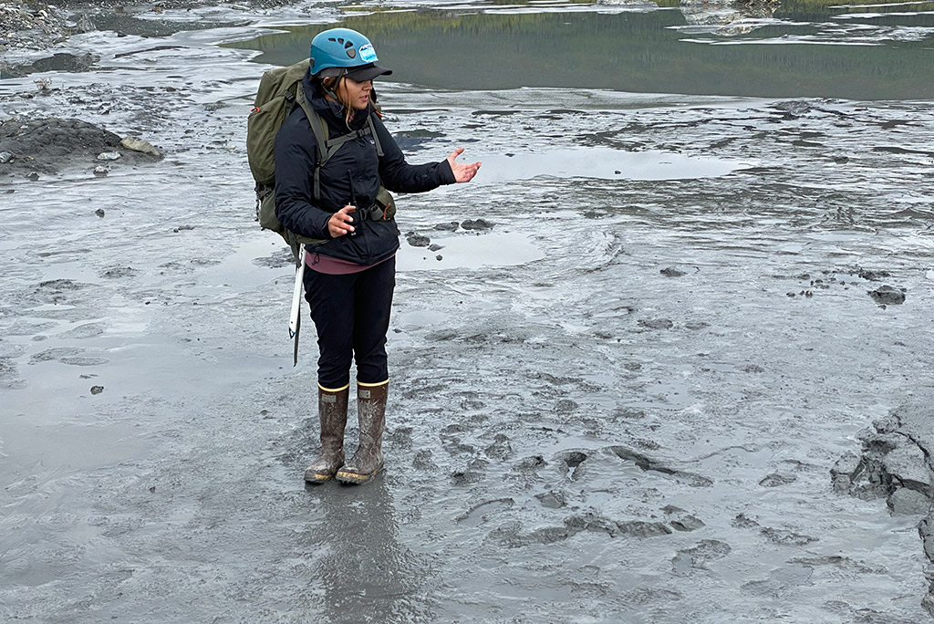 Our Guide Hiking On The Muddy And Icy Dirt.