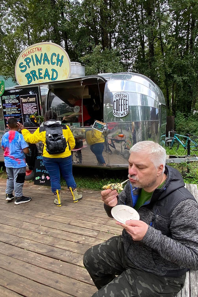 Chris eating Spinach Bread from Fun & Tasty Food Truck.