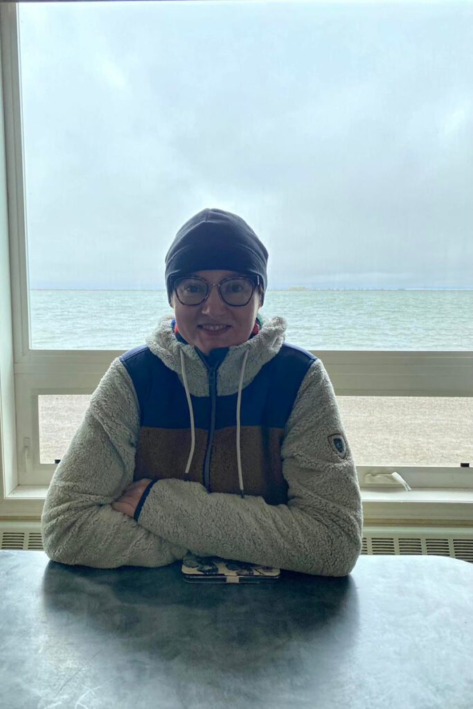 Agnes Stabinska, the author, in Deadhorse Camp with the Arctic Ocean in the backdrop.