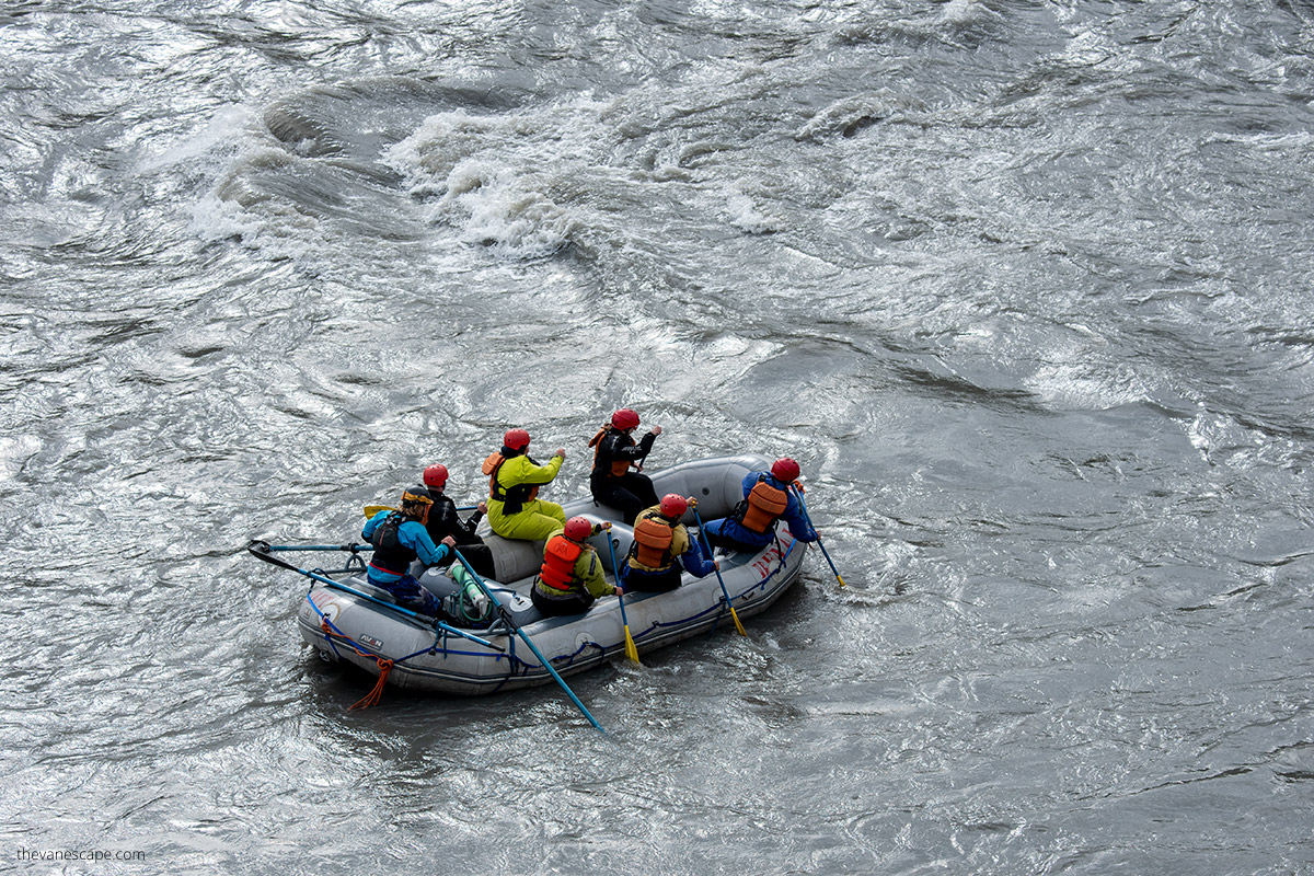 People rowing on the river during Denali white water rafting trip.