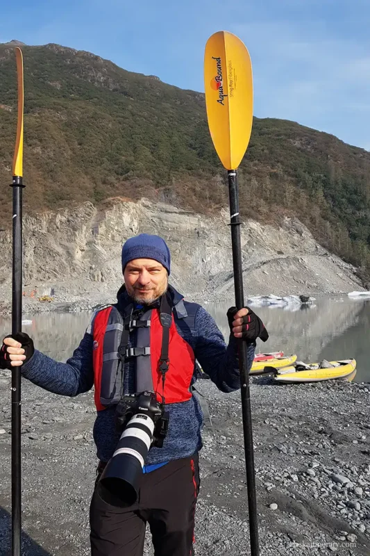 Chris holds the paddles before heading out on a kayak trip.