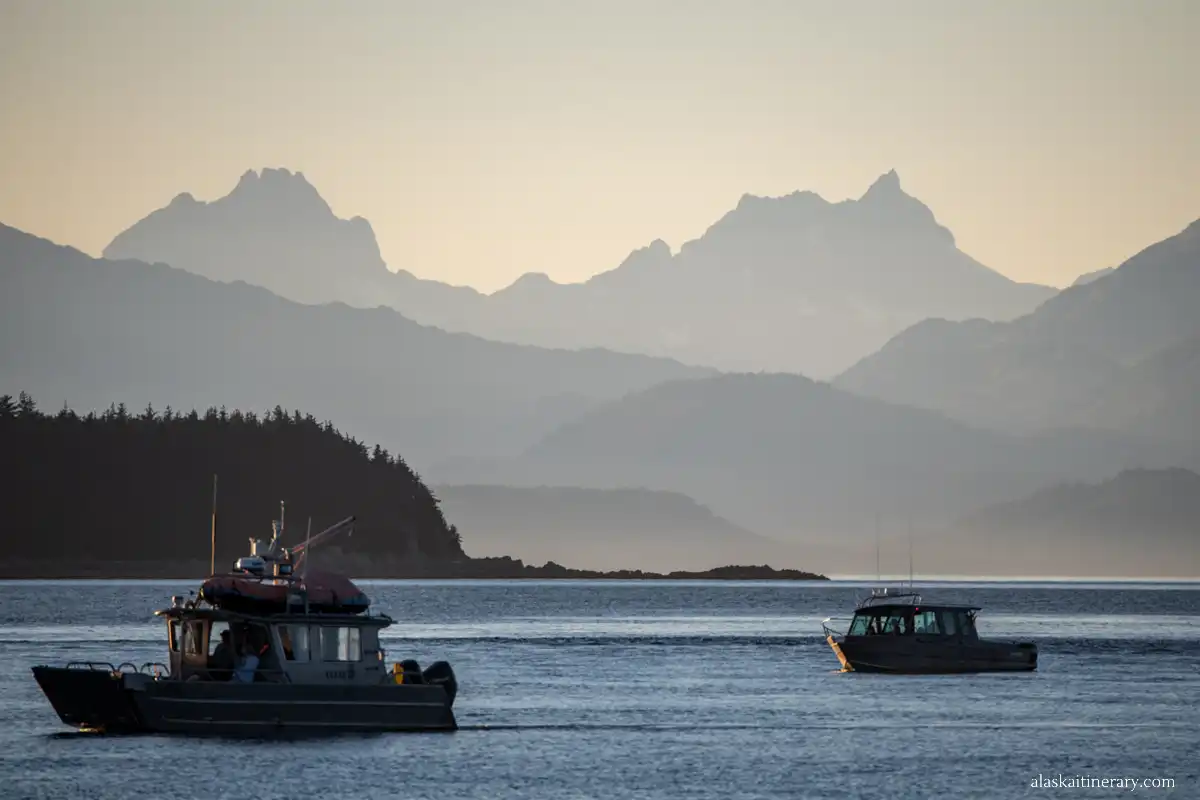 Vew of boats and mountains in Juneau during sunset.