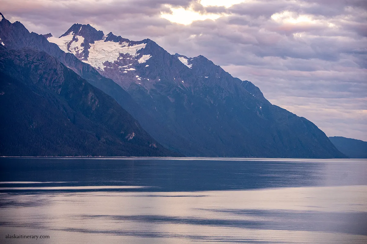 Sunset over the Glacier Bay National Park with glaciers and mountains from a cruise ship.