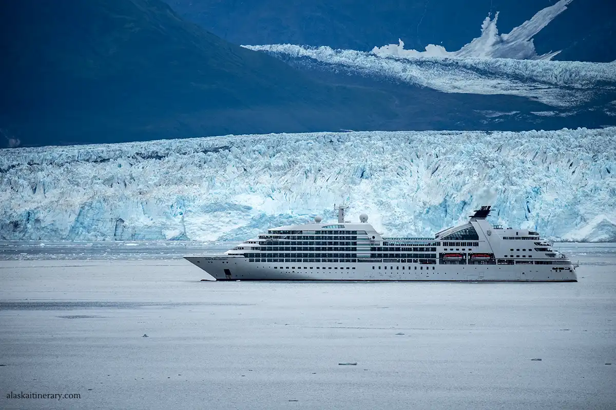 Luxury cruise ship with huge Hubbard Glacier in the backdrop.