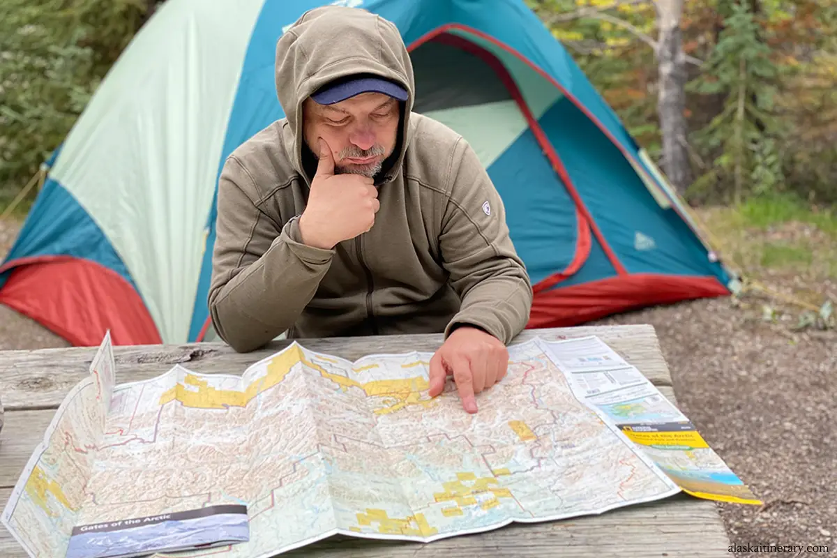 Chris with the map on our campsite near coldfoot, planning how to visit gates of the arctic national park.
