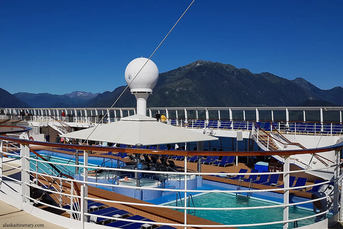 Norwegian Sun cruise ship review - view of the ship pools with Alaskan mountains in backdrop.