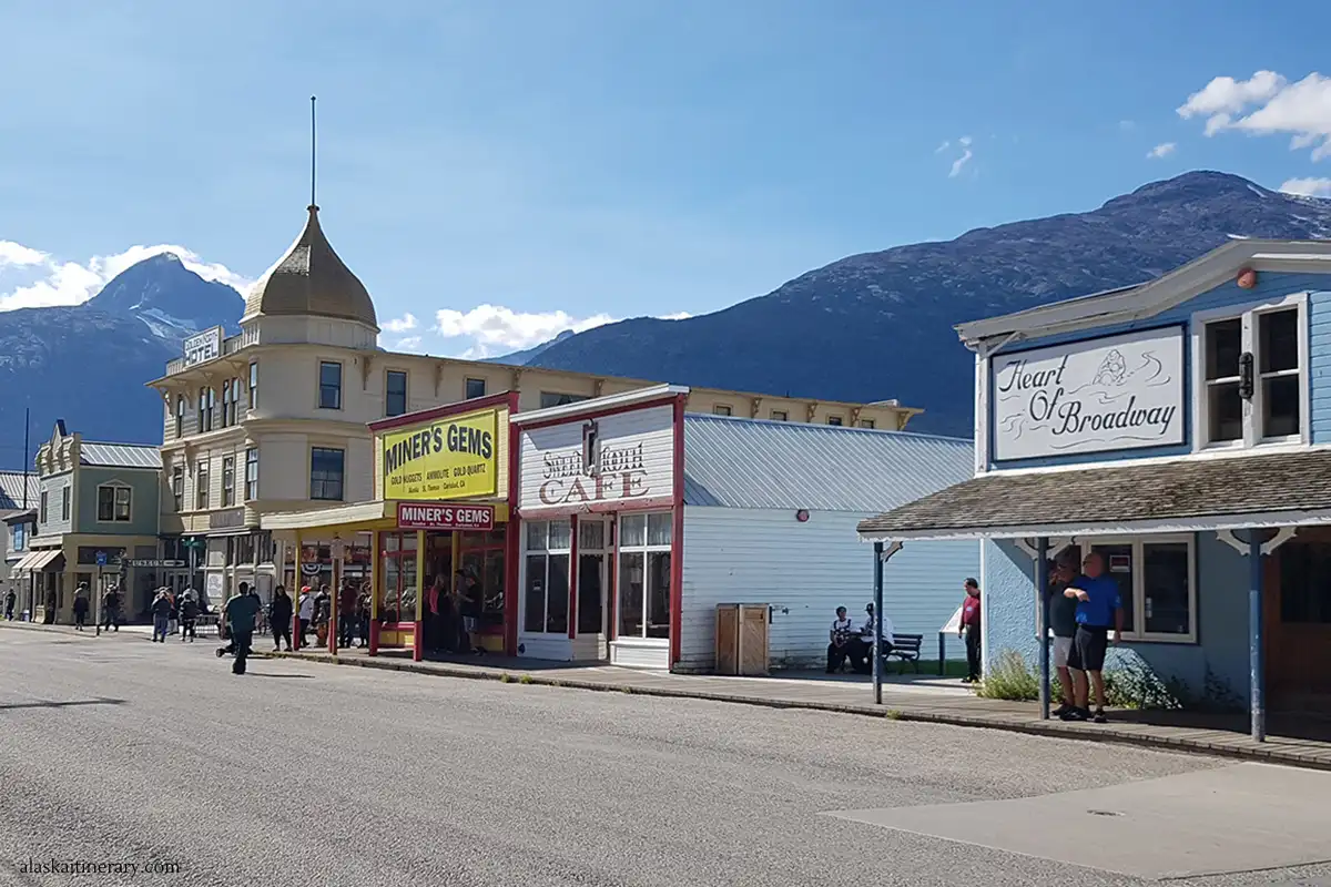 historical district in Skagway with wooden architecture and mountains in the backdrop.
