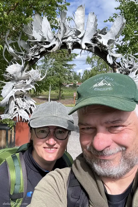 Agnes Stabinska, the author, with her partner Chris Labanowski in Fairbanks next to attraction known as the Antler Arch.