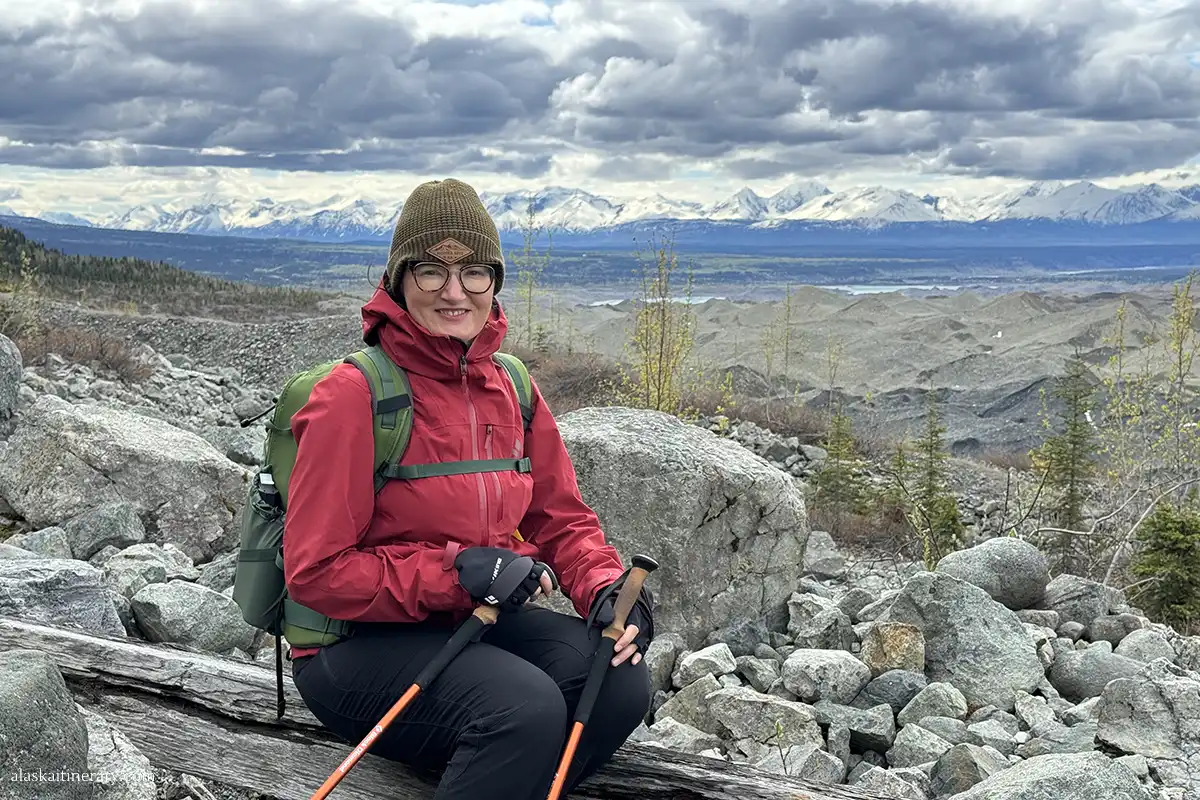 Agnes Stabinska, the author, with red windproof jacket and with trekknig poles during hike in Wrangell St.Elias National Park.