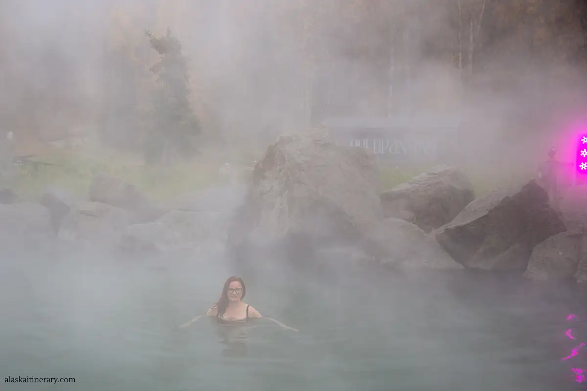 Agnes soaking in Chena Hot Springs after long RV driving. The image is blurry from the hot steam and fog in the air.