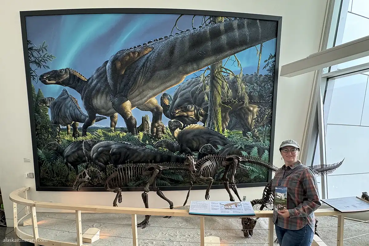 Agnes Stabinska, the author, in the Museum of the North, next to the skeleton of dinosaurs.
