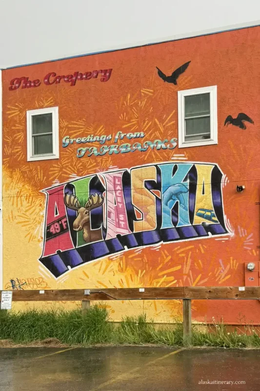 Colorful mural in downtown with the sign Greetings from Fairbanks Alaska.