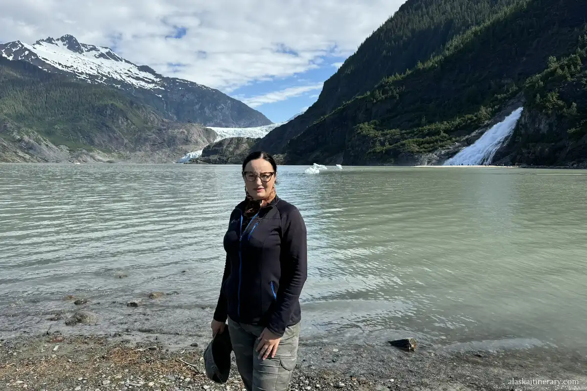 Agnes Stabinska, the author, in Juneau with the view of the Mendenhall Glacier and Nugget Falls in the backdrop.