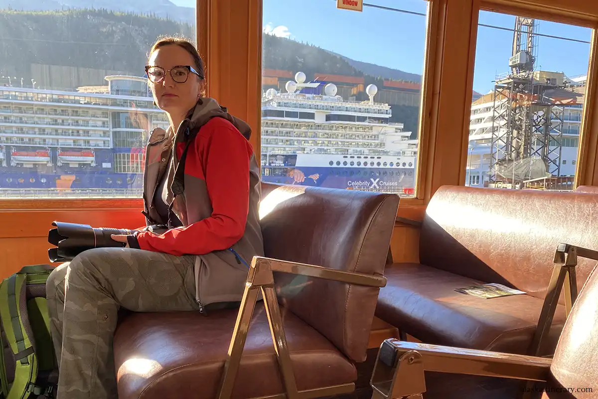 Agnes during Skagway Train Tour sitting on brown leather seats of a vintage train.