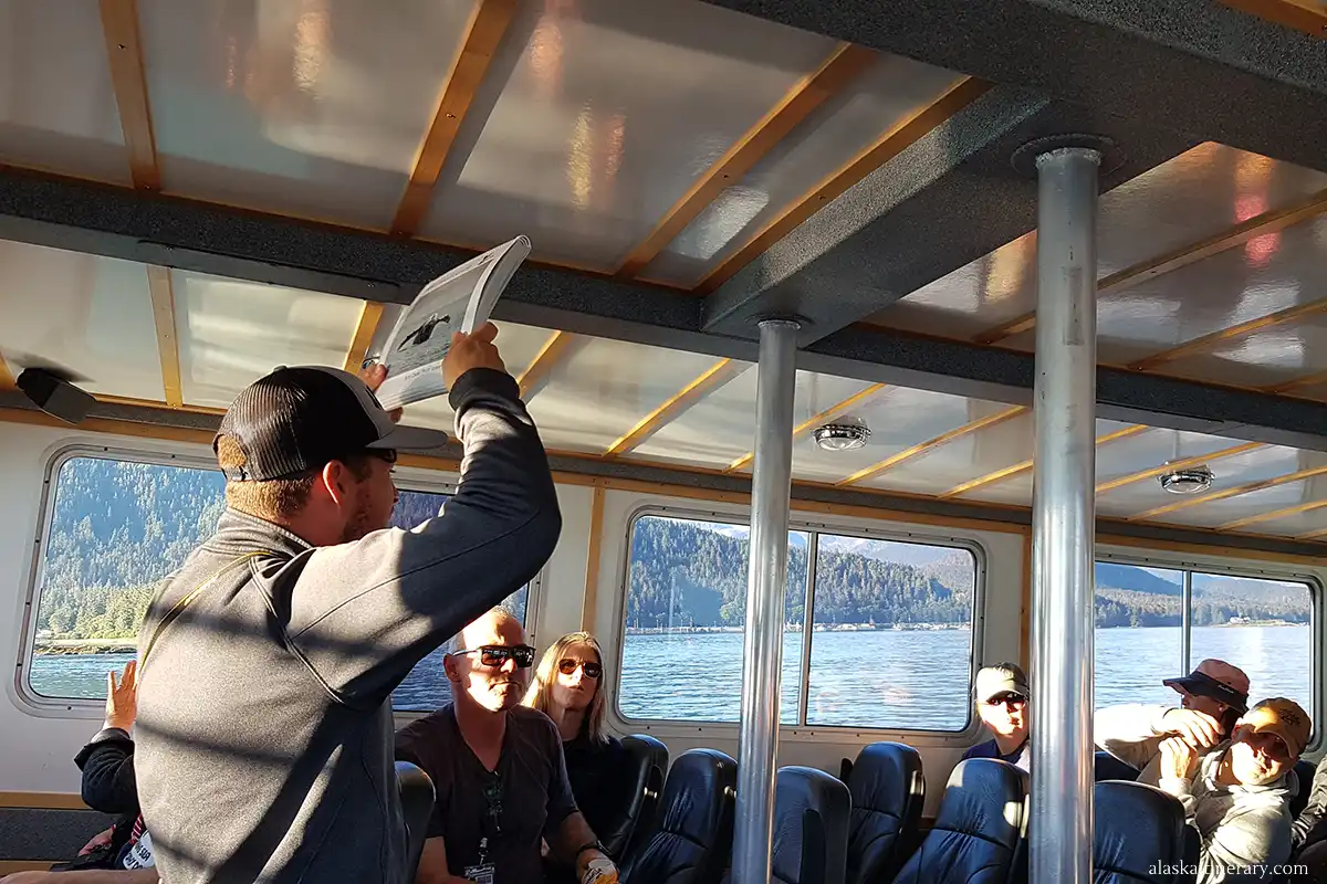 our guide on vessel showcasing photos of whales.