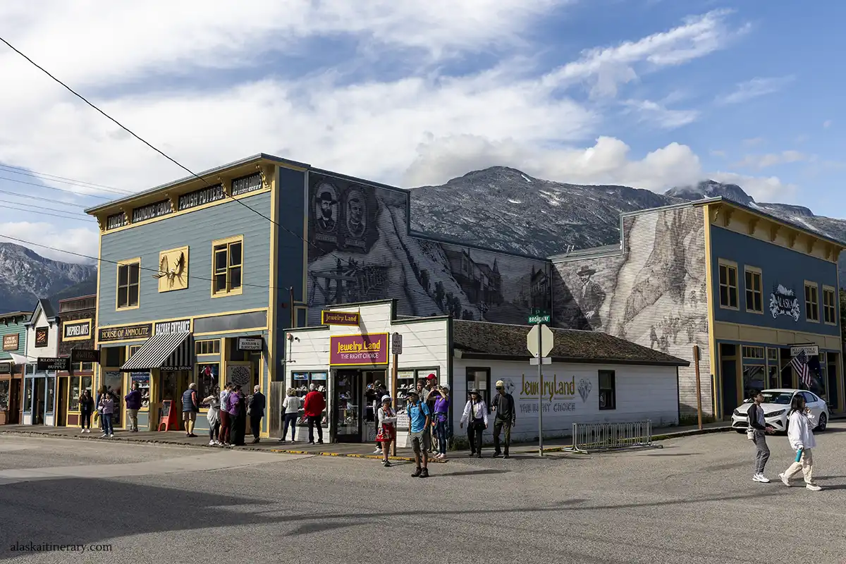 Downtown Skagway: wooden historical buildlings and people on the street.