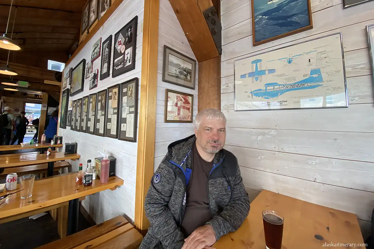 Chris is sitting with a beer in Alaska Fish House in Ketchikan.