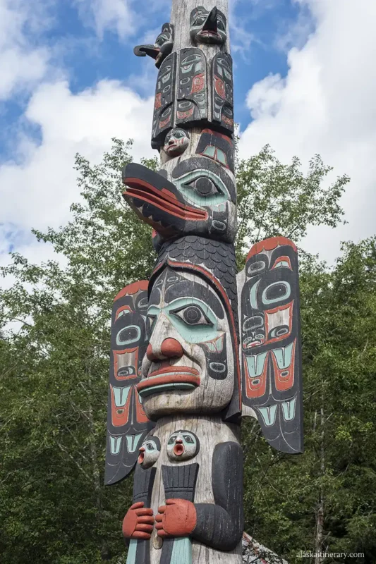 Totem pole in Ketchinak with carved birds, animals, Native tribes.