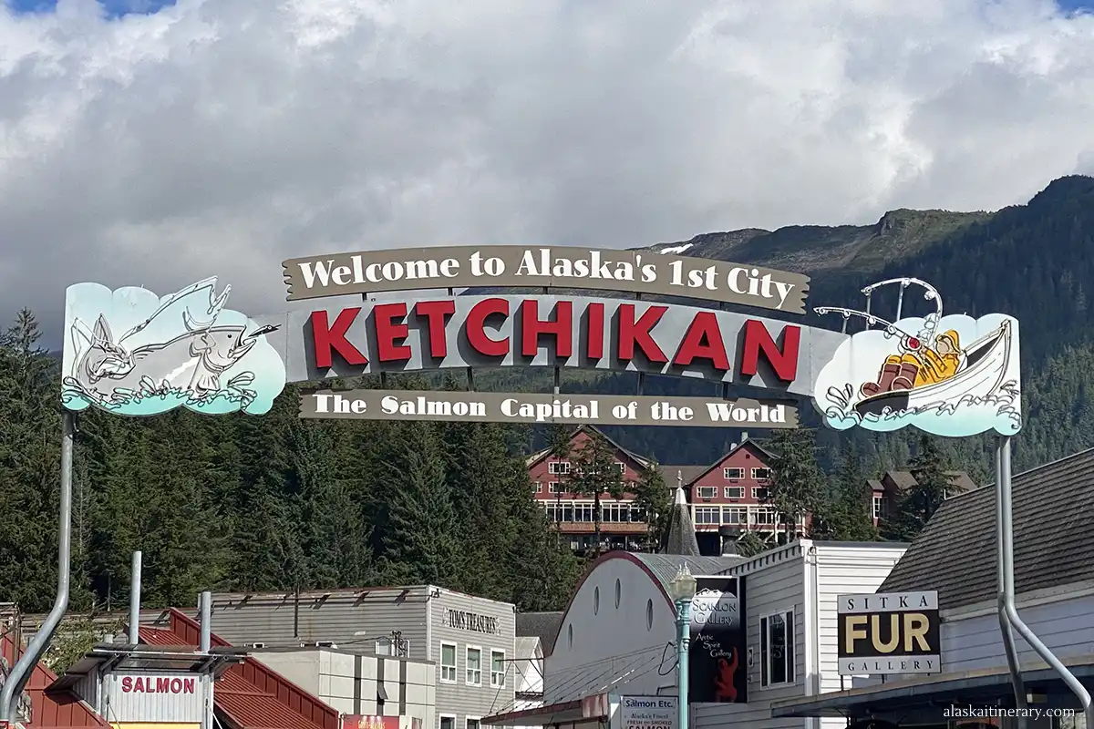 Welcome to Ketchikan' Sign with mountains and houses in the backdrop.