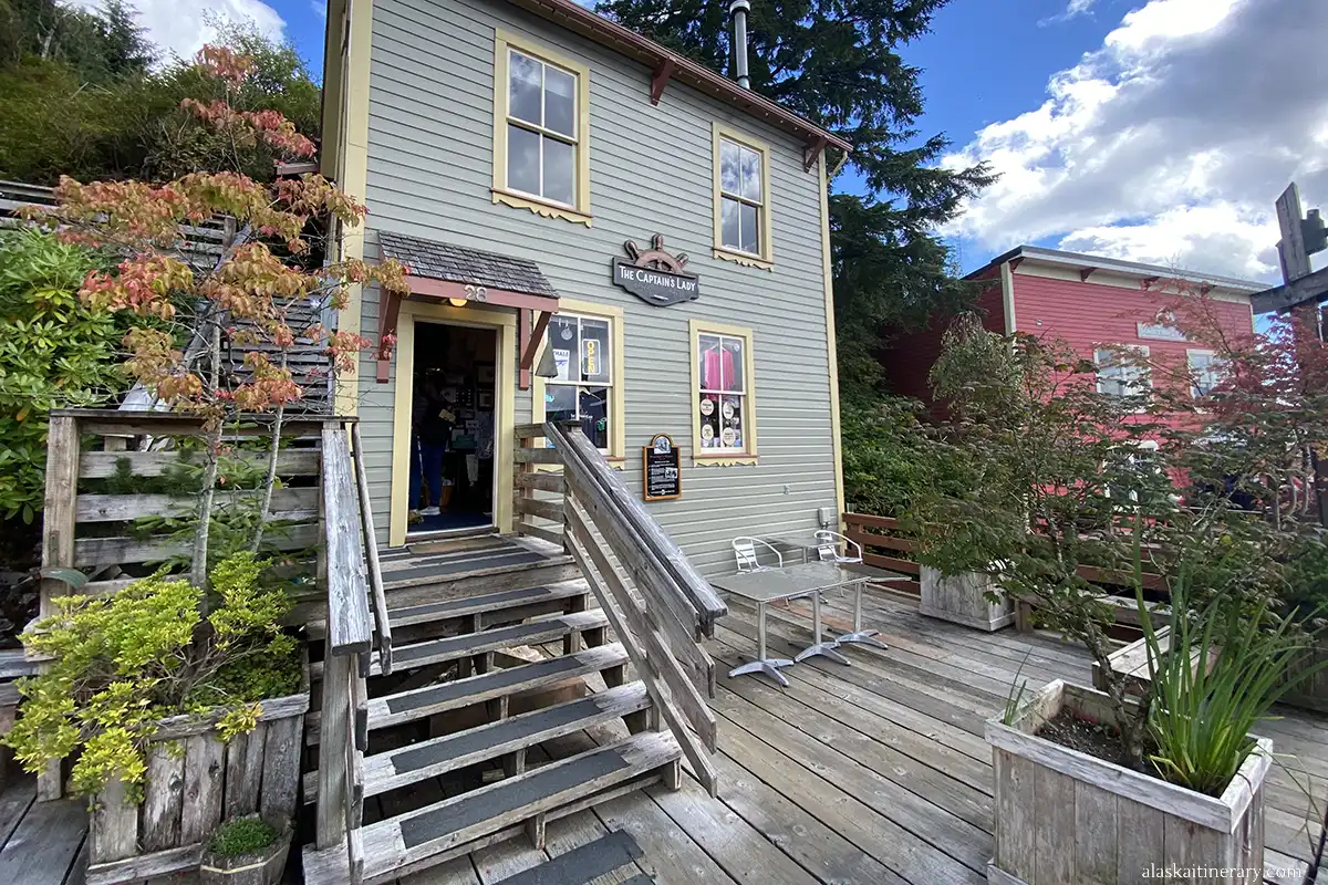 A souvenir shop with a green terrace and several steps leading inside.