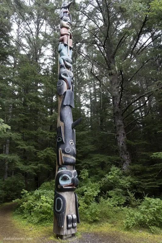 Tall totem pole in Sitka carved with animal faces.
