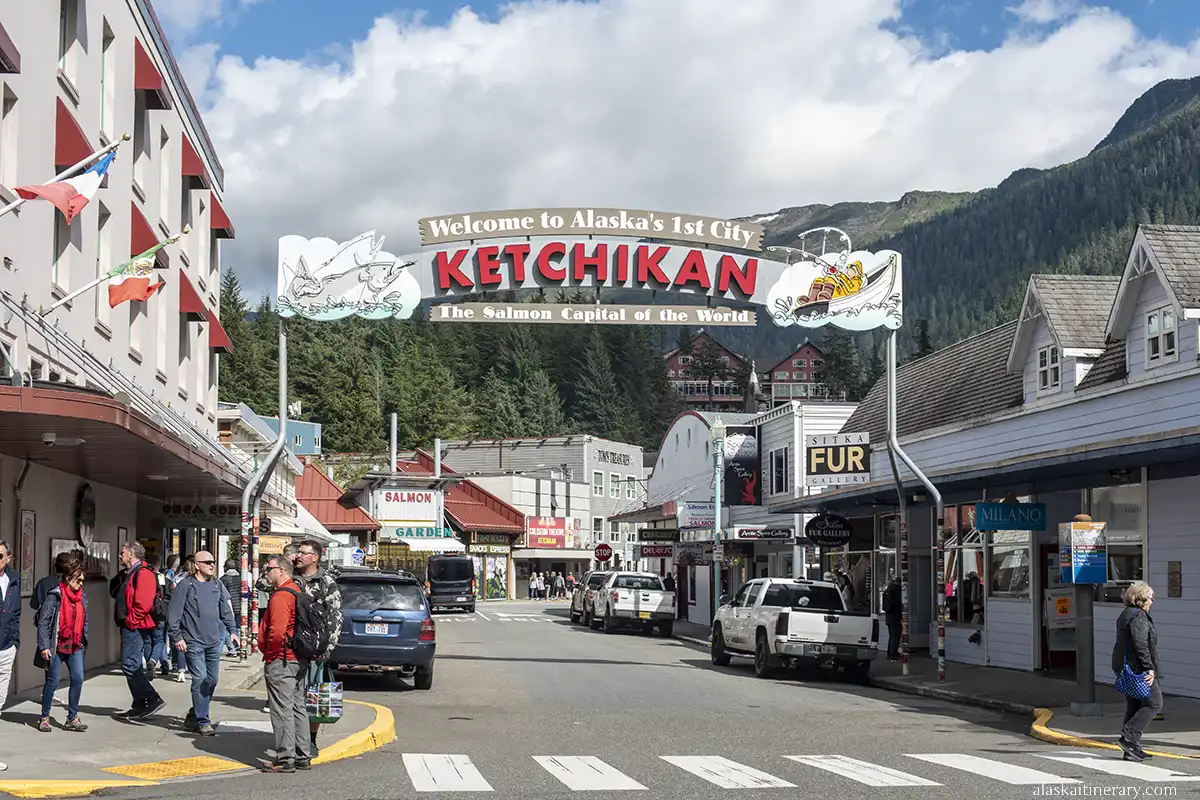Welcome Arch in downtown Ketchikan with mountains in the backdrop.