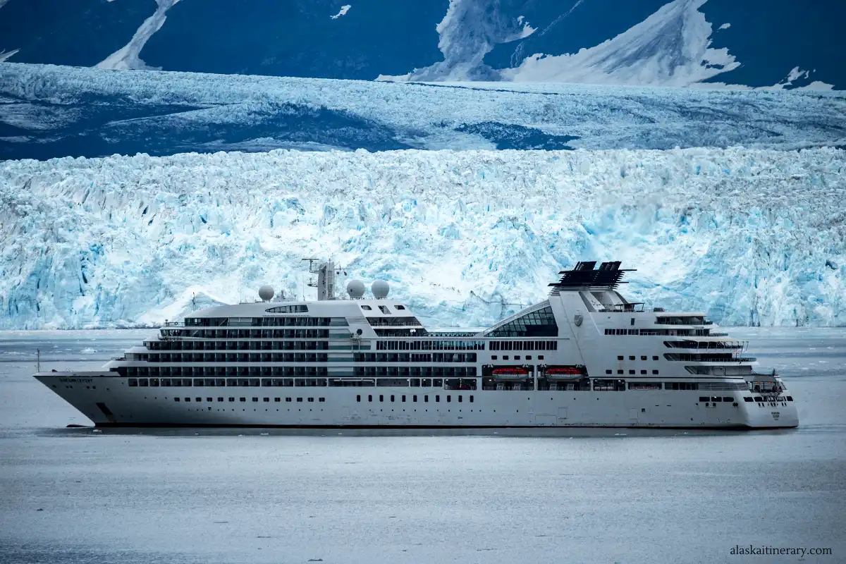 Cruise ship crusing alonge huge Hubbard Glacier in Alaska. 