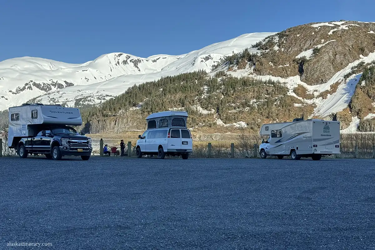 RVs on the Whittier City campground with the mountains in the backdrop.