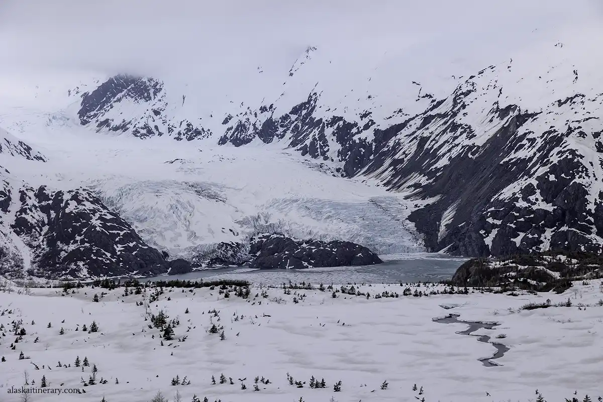 Portage Glacier and Portage Lake in snowy scenery in May.