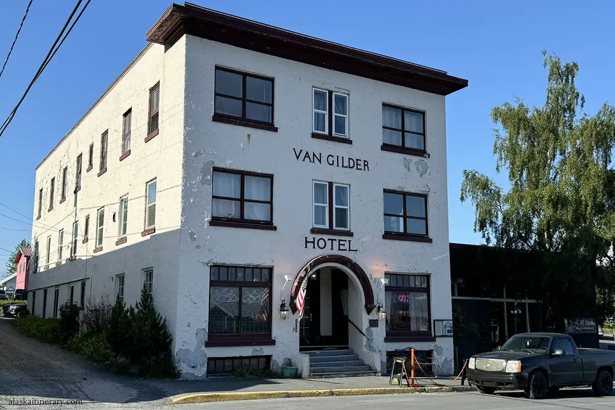 White facade and brow entrance to the Van Gilder Hotel in Seward.