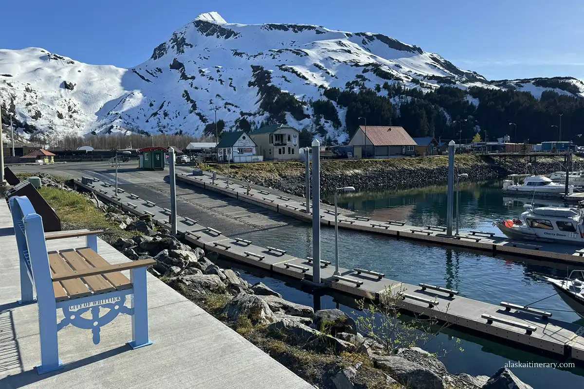 Whittier harbor with small boats and view of the mountains.