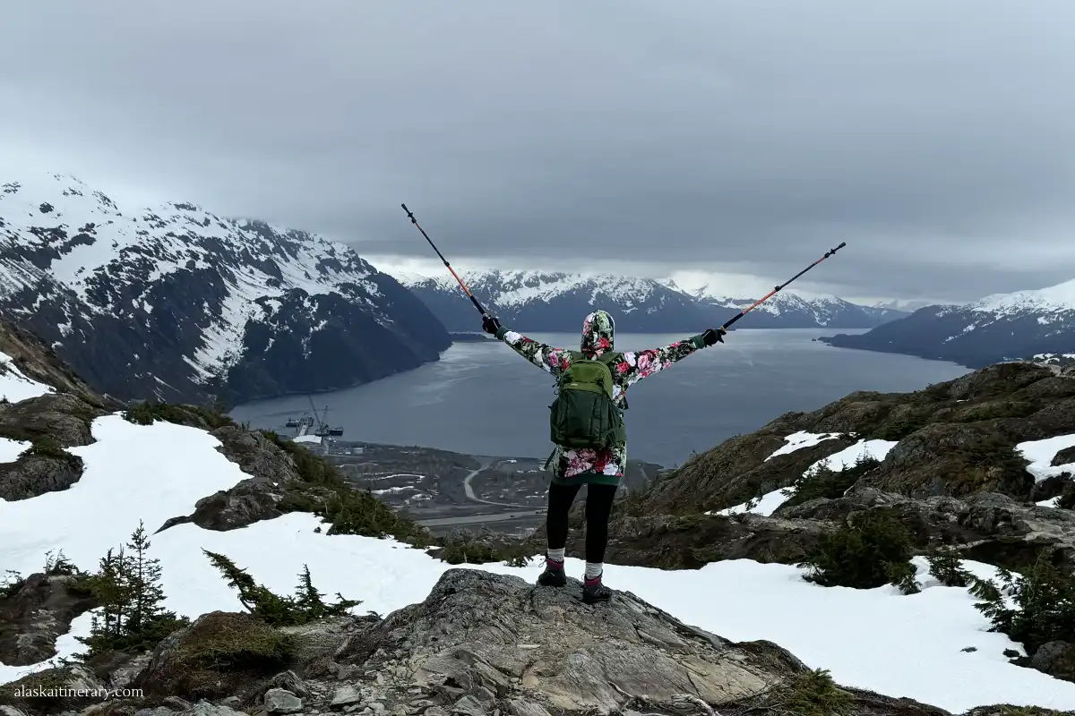 Agnes Stabinska, the author, at Portage Pass trail in Whittier with scenic view of the bay and mountains.