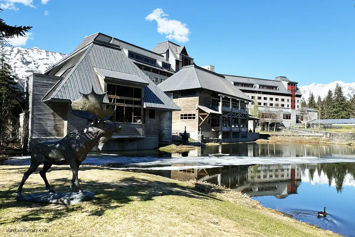 Hotel Alyeska Resort in Girdwood with ponds at front and the statue of moose.
