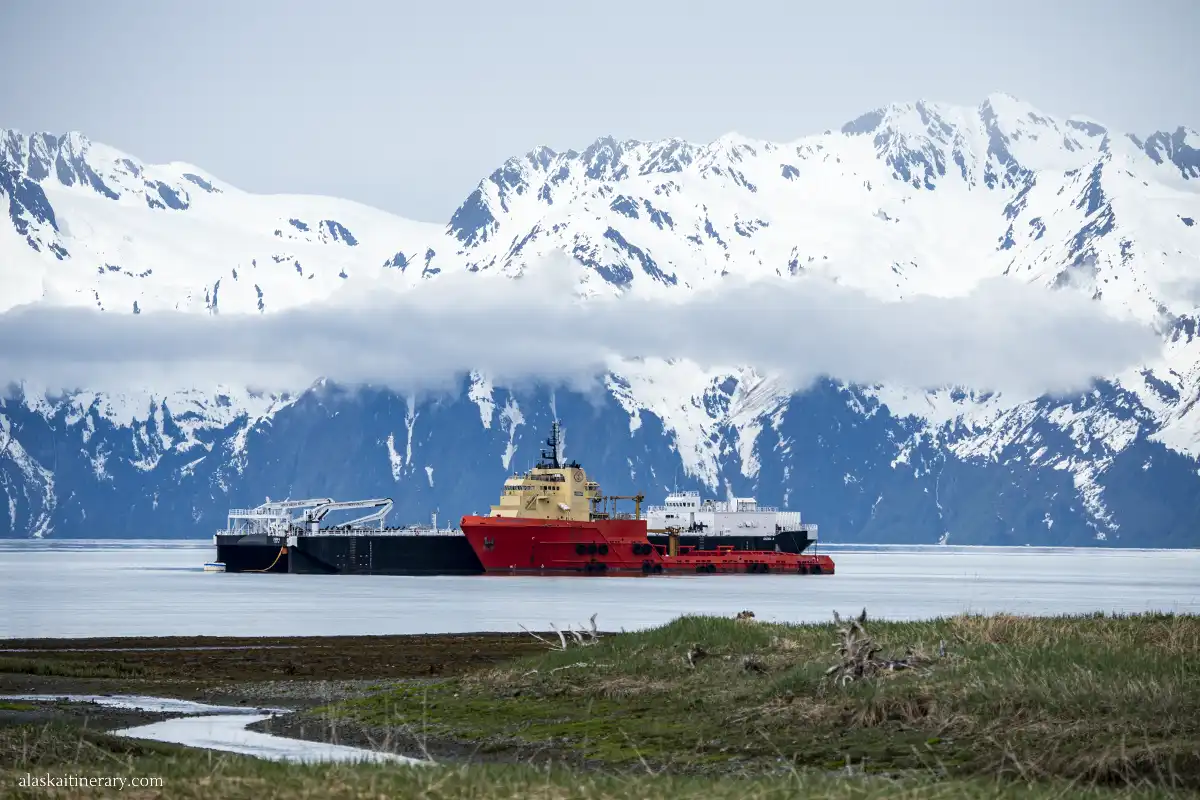 Port in Valdez with ferry and mountains in the backdrop.