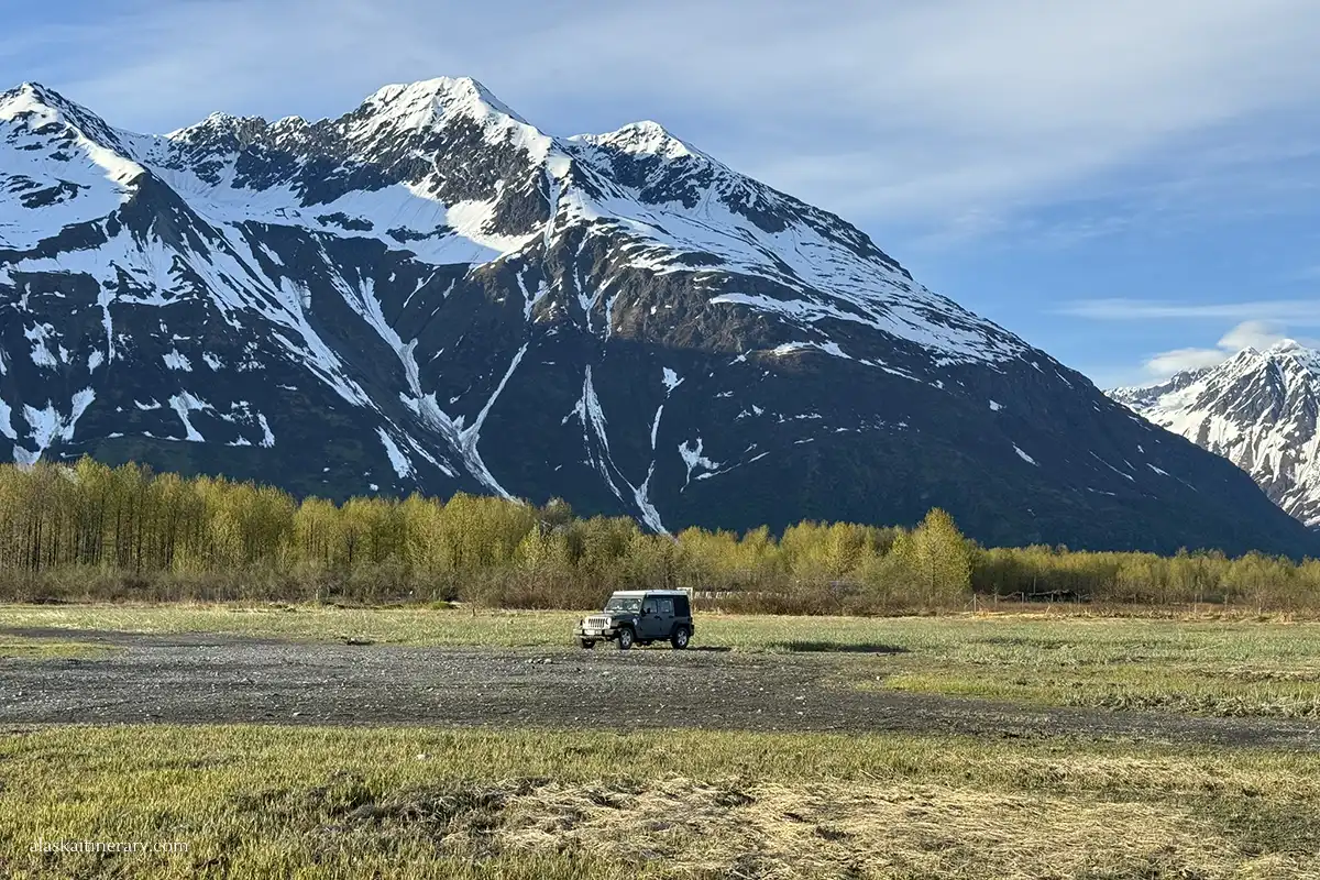 Rented jeep with roof-top-tent with stunning Alaska mountains in the backdrop.