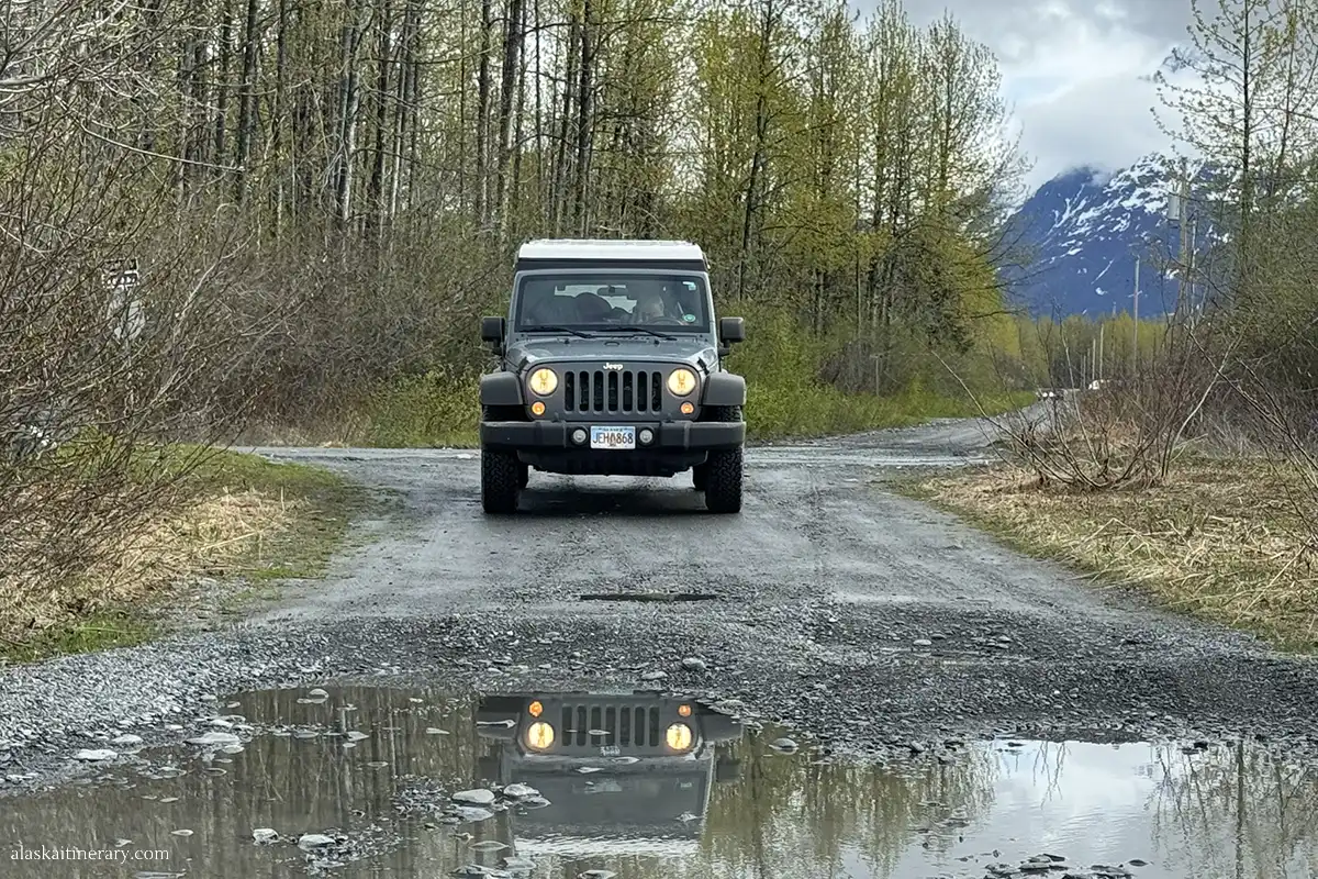 Jeep wrangler on a gravel road in Alaska.