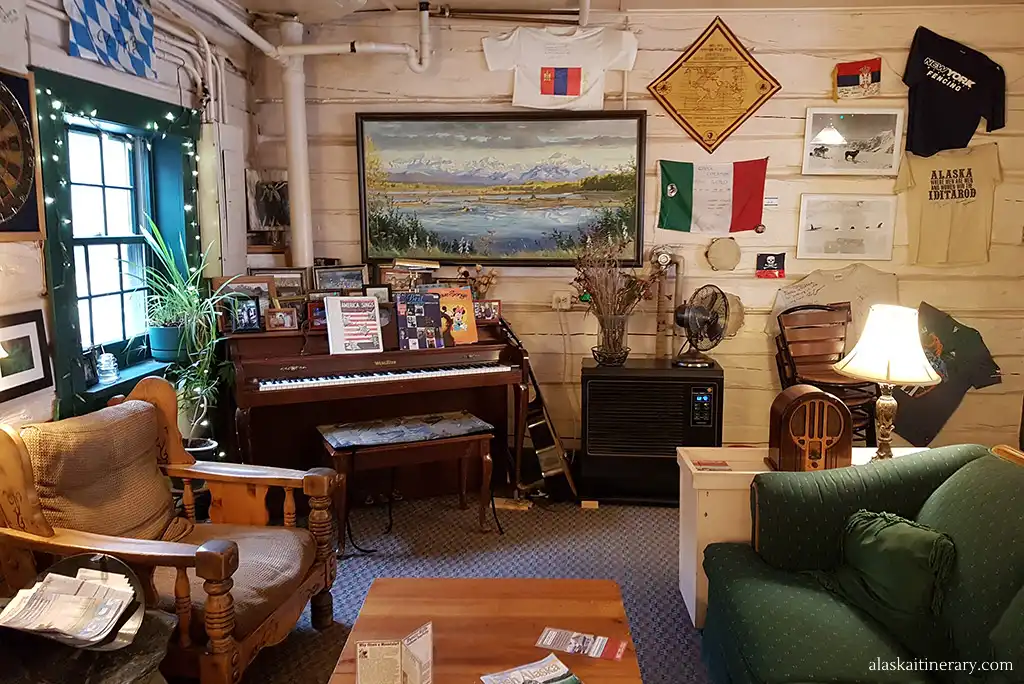 The piano, chairs and cozy interior in Talkeetna Roadhouse.