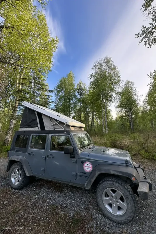Jepp Wrangler with a roof top tent on the caming near Talkeetna.