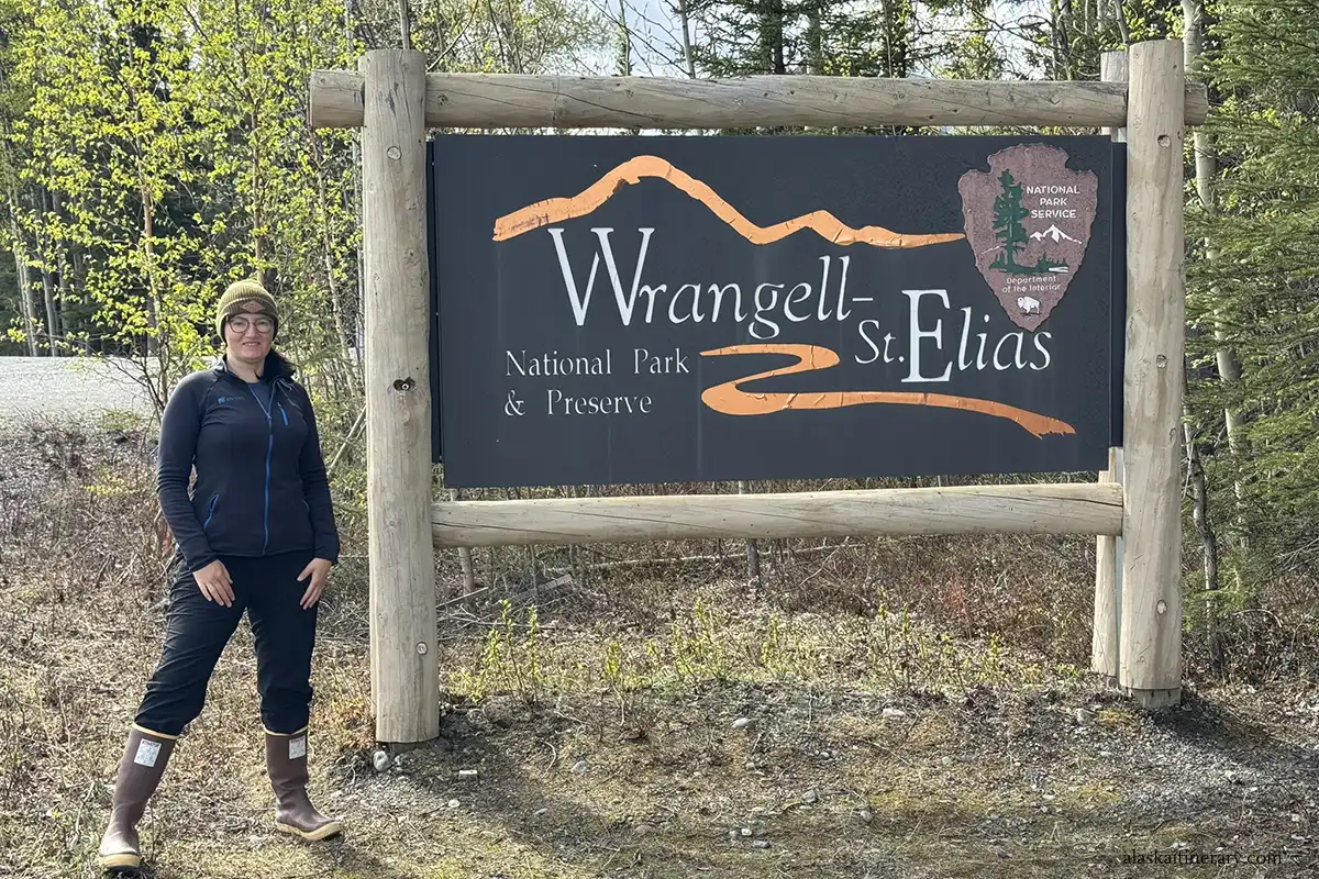 Agnes Stabinska, the author, at the entrance to Nabesna Road next to sign: Wrangell-St.Elias National Park and Preserve.