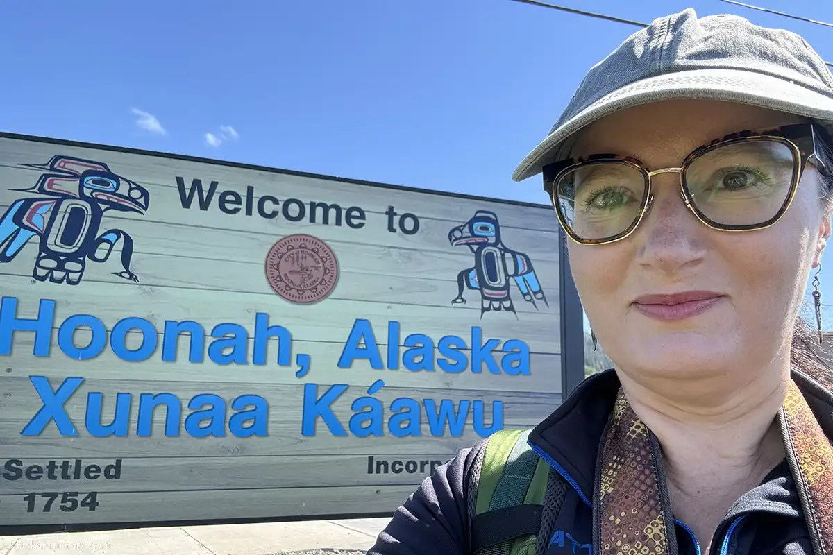Agnes Stabinska, the author, next to Welcome to Hoonah sign.