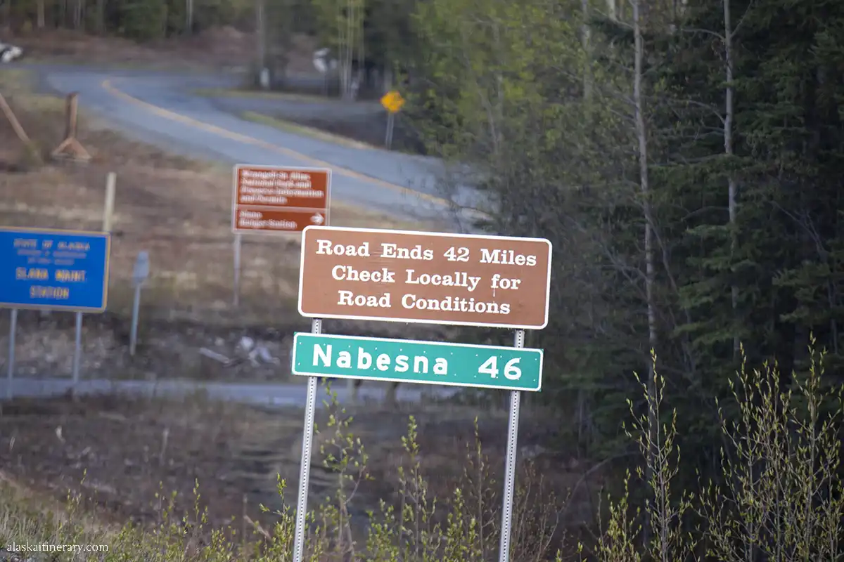 Road sign: Nabesna 46 Road ends 42 miles, check locally for road conditions.