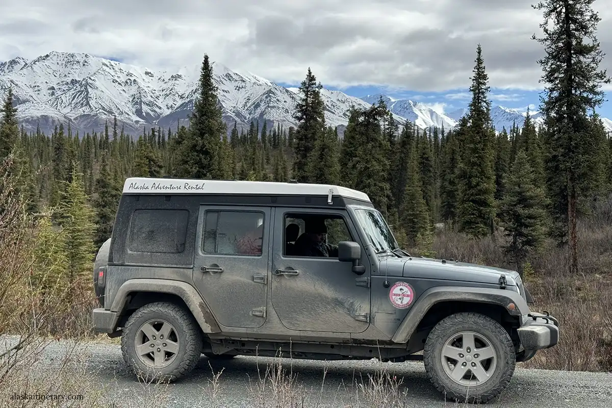 Our rented jeep wrangler on Nabesna Road with stunning Wrangell Mounrains views in the backdrop.
