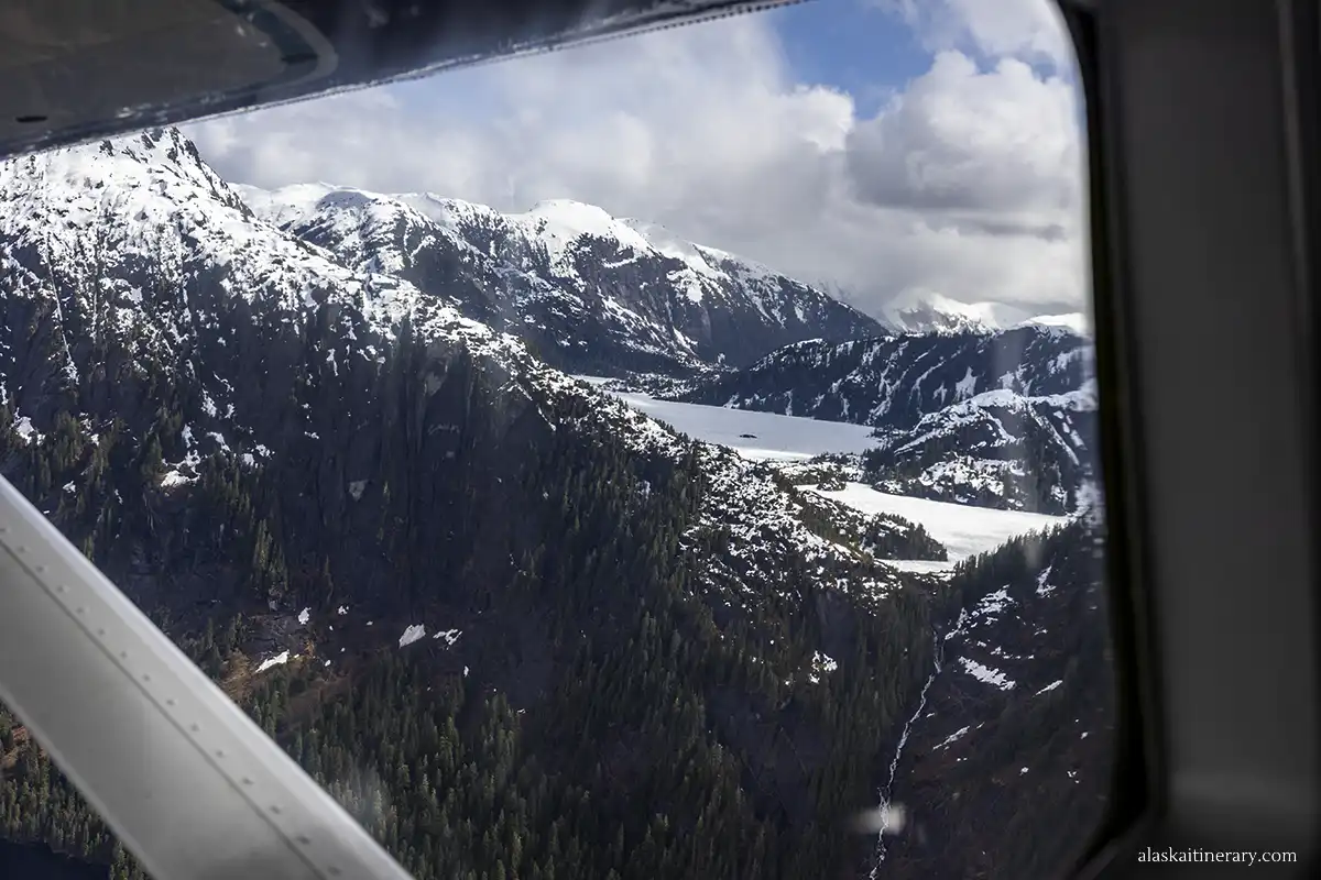 Mountain view and frozen lake from the floatplane window.