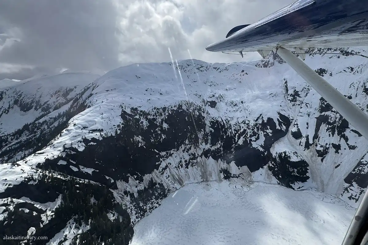 Frozen lake and mountains covered by snow - the view from the floatplane.
