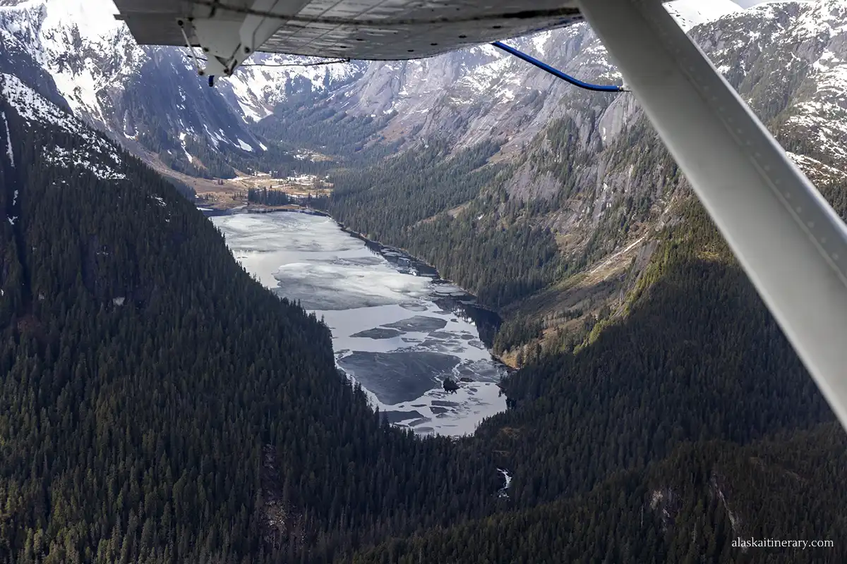 U-shaped valley with deep water and surronded by steep cliffs from floatplane.