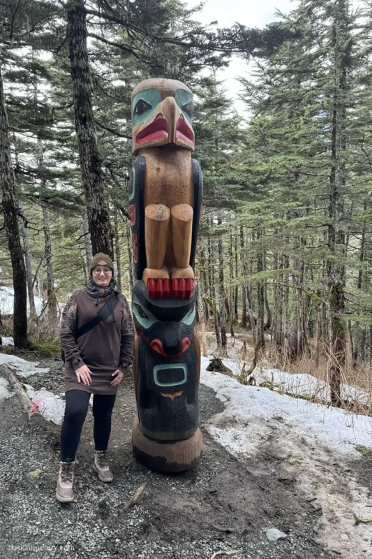 Agnes Stabinska, the author, next to wooden totem pole in Juneau.