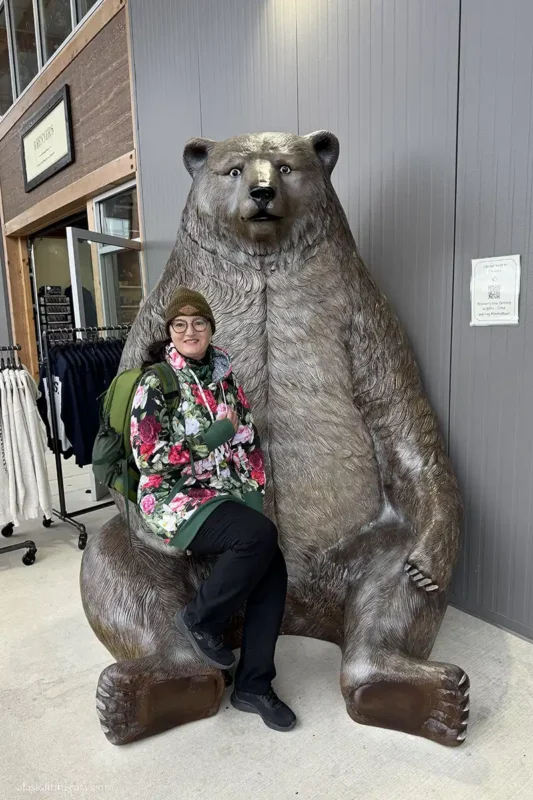 Agnes Stabinska, the author, next to the huge wooden brown bear statue in Sitka Sound Cruise Terminal.