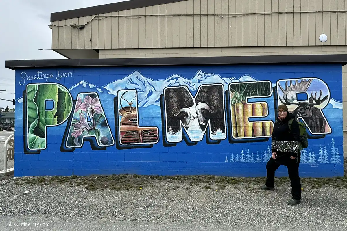 Agnes Stabinska, the author, at the front of mural: greetings from Palmer.