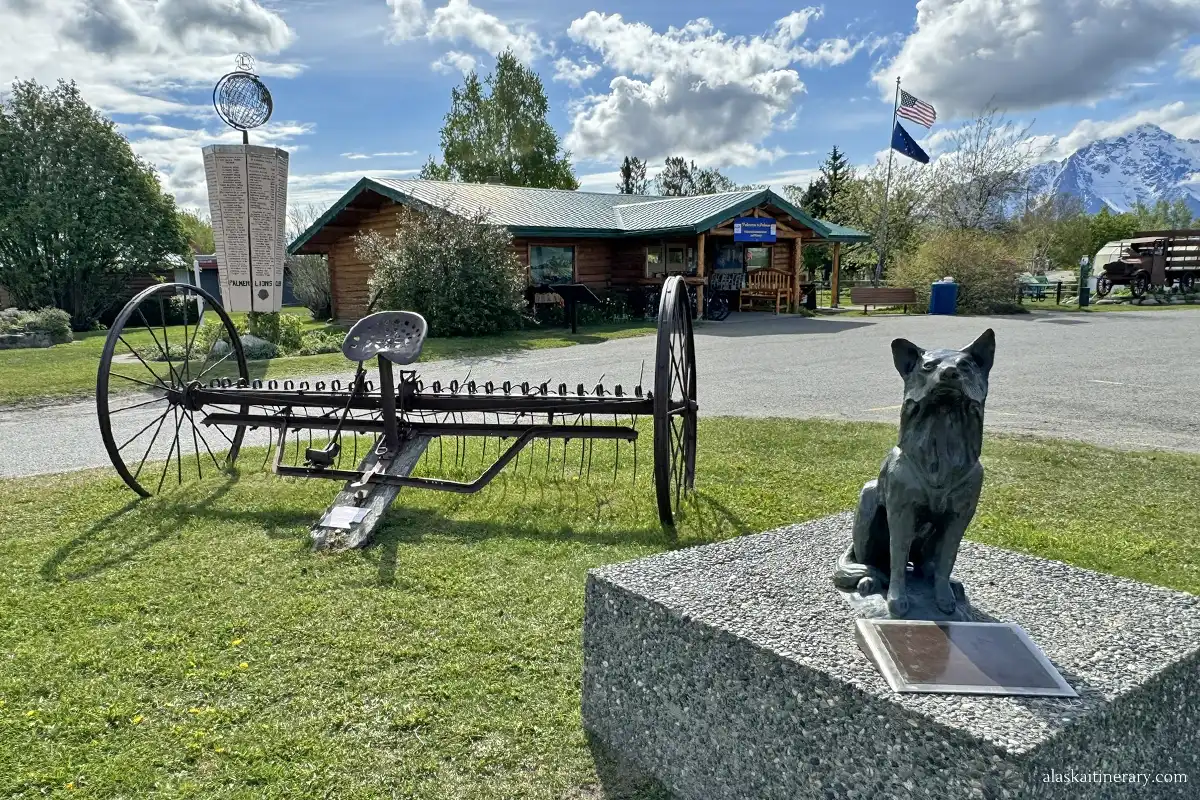The Palmer Visitor Center with the dog statue and agricultural machines at the front.