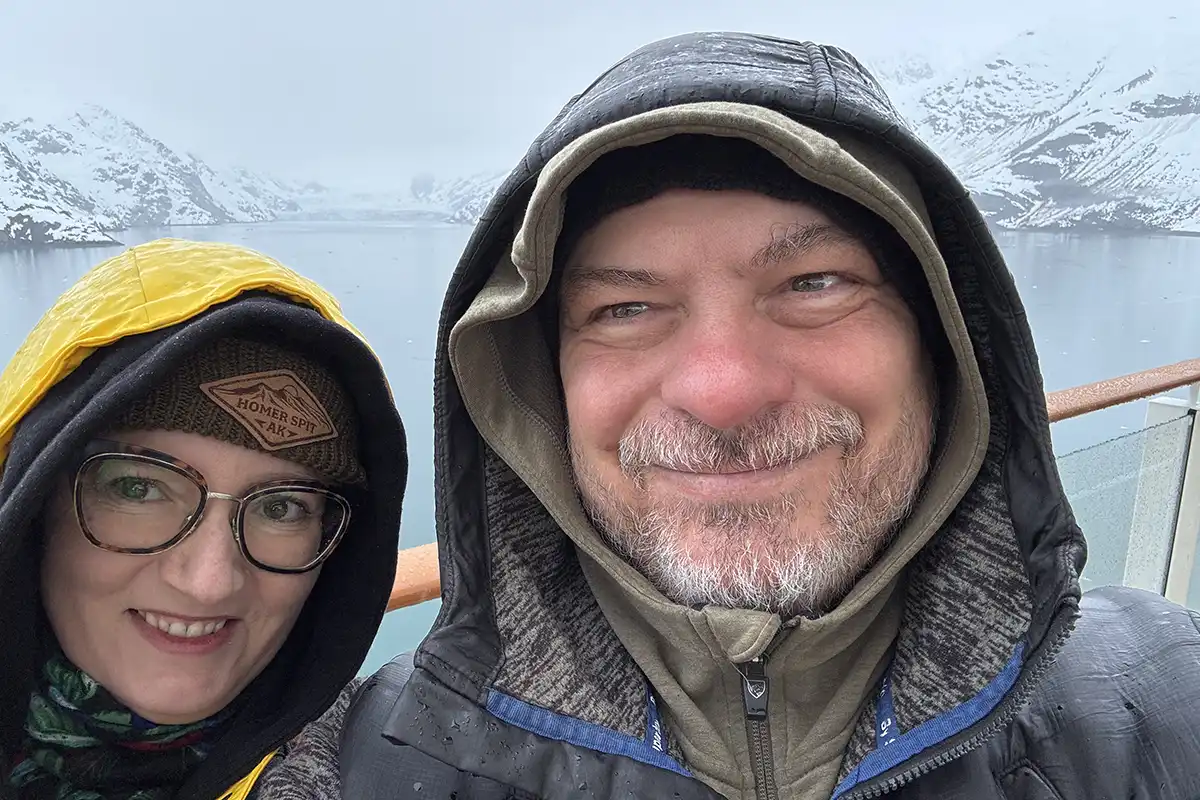 Agnes Stabinska, the author, with her partner Chris in warm hats and waterproof jackets during rainy and foggy day in Glacier Bay.